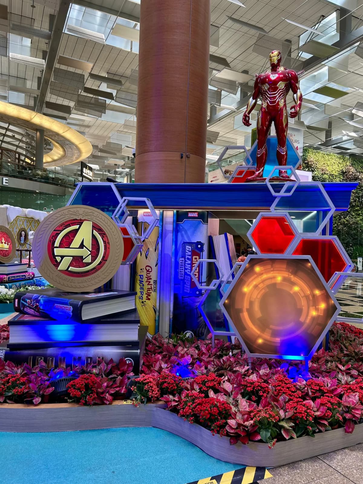 Marvel Landing display with an Iron Man statue and Avengers crest at Changi Airport