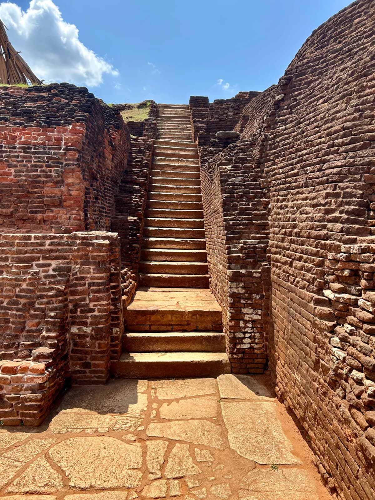 Ancient stone stairs leading around the top layer of the Sigiriya palace ruins