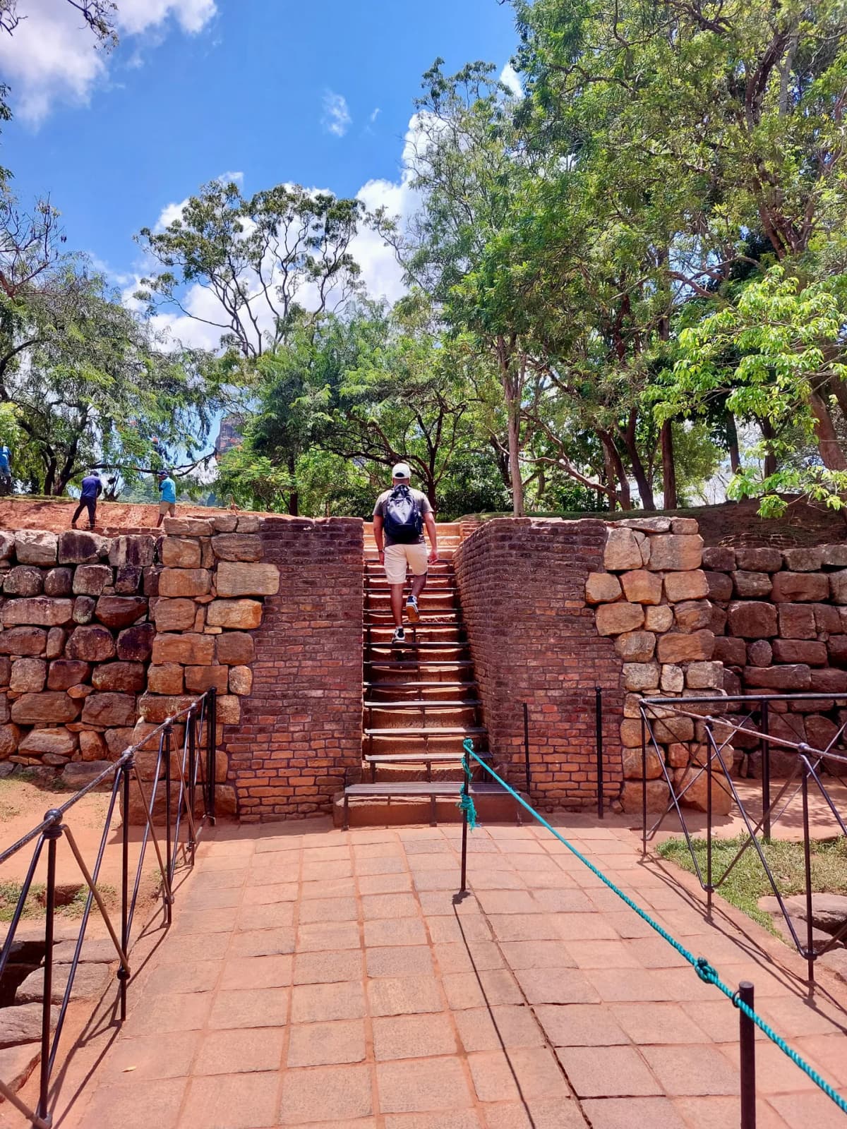 Stepping up the steep metal stairs towards the ancient palace summit